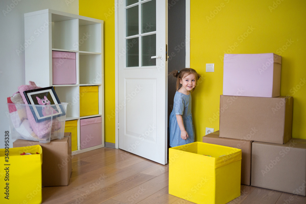 kid moves into her new room. moving to apartment. child looks into the nursery