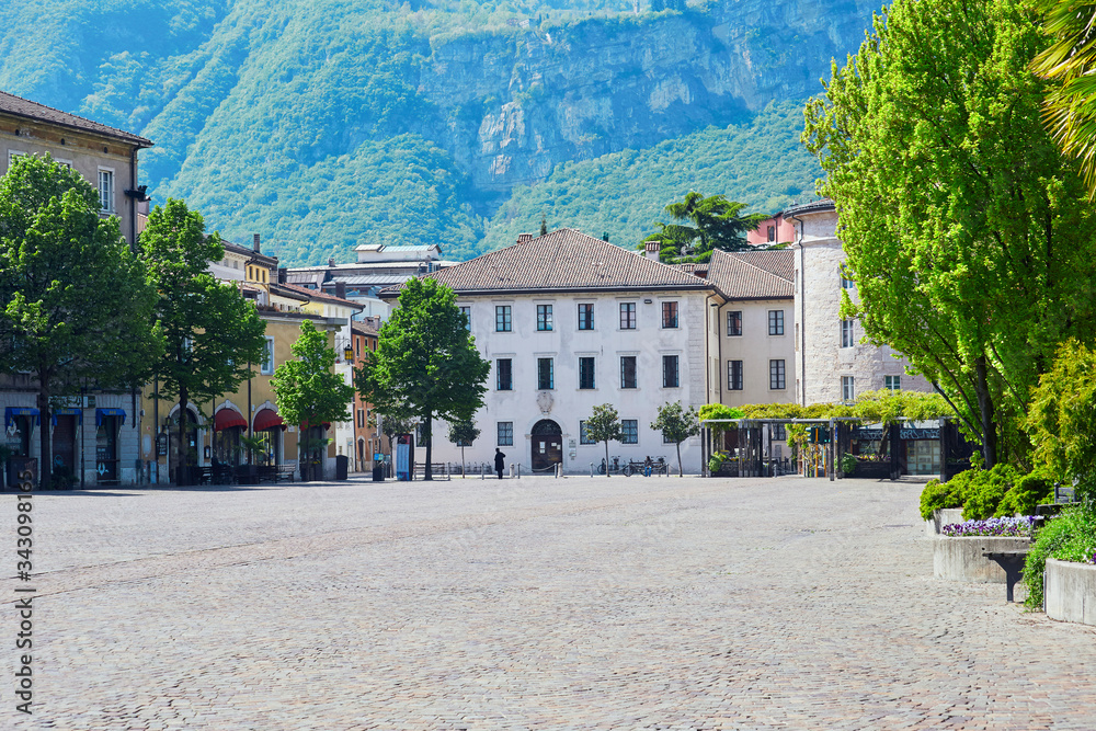 Naklejka premium Old historyc market square in the italian city Trento with nobody on it, empty of people street. With Alpine mountain wiew on the background