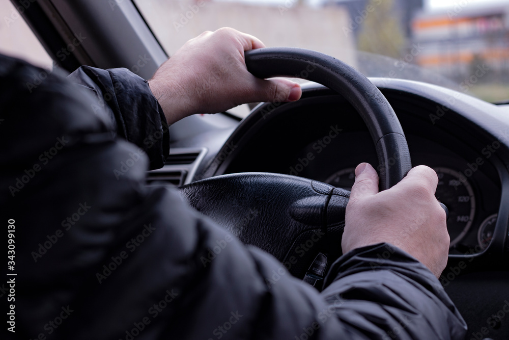 Man black jacket on driver place with steering wheel in hands. Man black jacket on driver place with steering wheel in hands.