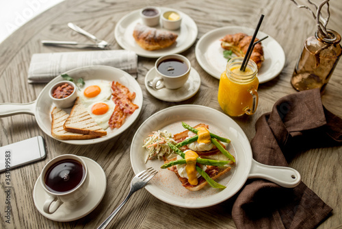 Breakfast with coffee toast with egg juice daylight cafe restaurant towel american wooden table