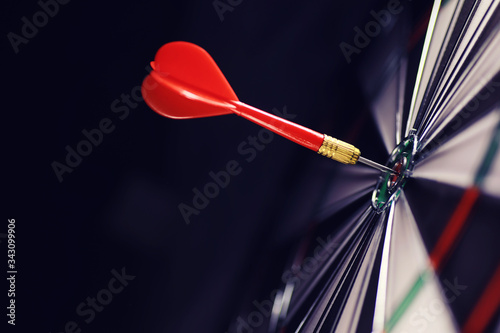 Darts. The dart for playing in the game board is stuck. Hit sector in darts. The concept of a successful strategy.