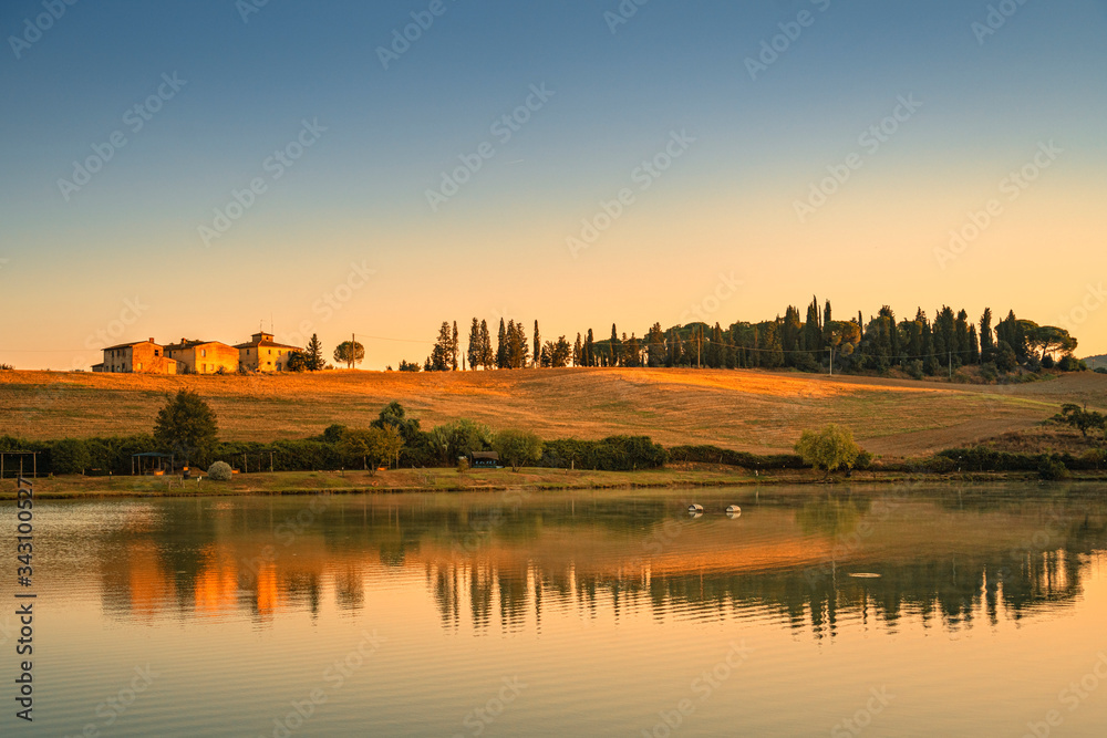 Summer sunrise over the lake and farm. Travel destination Chianti, Tuscany