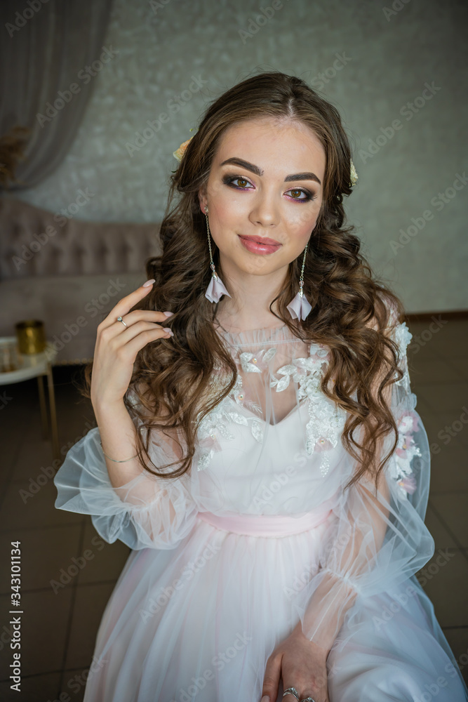 Beautiful festive make-up on a girl in a white dress. Beautiful festive make-up on a girl in a white dress.