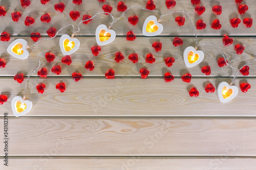 hearts garland on a wooden background top view