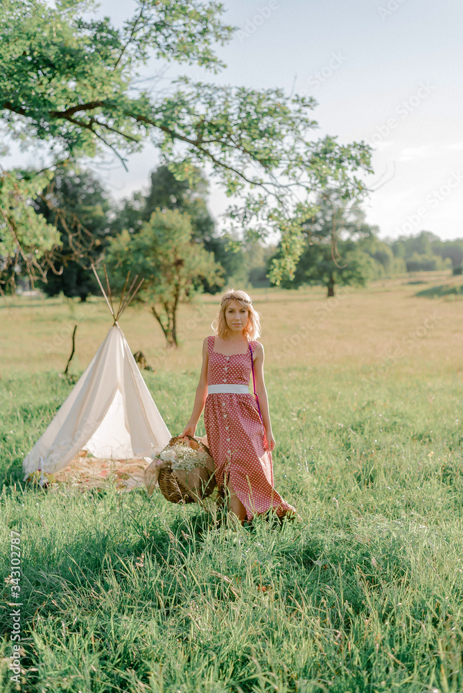 Beautiful young girl in dress with a gypsophila wreath, green grass, beautiful sunset, boho decor, rustic decor, sunset time for a dream Beautiful young girl in dress with a gypsophila wreath, green grass, beautiful sunset, boho decor, rustic decor, sunset time for a dream