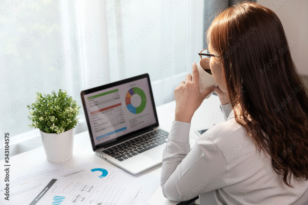 Women using laptop and drink coffee in home office, Young woman is making plans for the business. Women using laptop and drink coffee in home office, Young woman is making plans for the business.