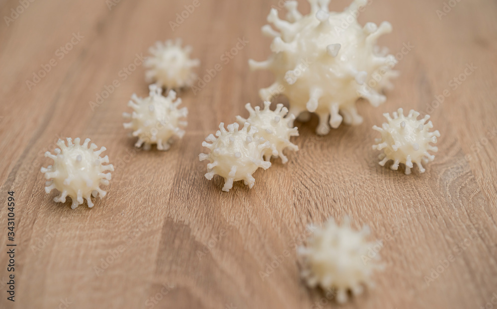 covid19, 3d printed representation of the virus on a wooden surface. home security and protection against viruses