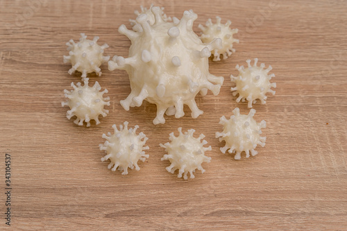 Fototapeta covid19, 3d printed representation of the virus on a wooden surface