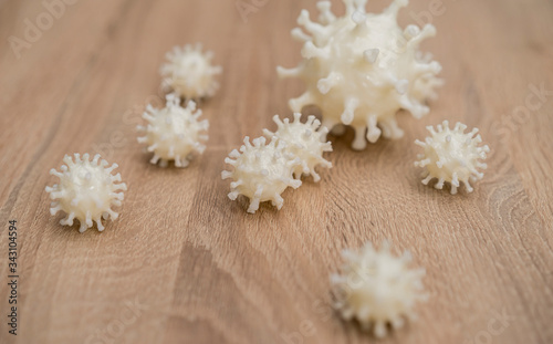 Fotografie, Obraz covid19, 3d printed representation of the virus on a wooden surface