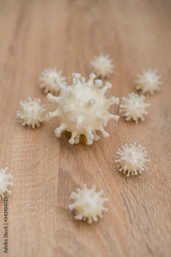 covid19, 3d printed representation of the virus on a wooden surface. home security and protection against viruses covid19, 3d printed representation of the virus on a wooden surface. home security and protection against viruses