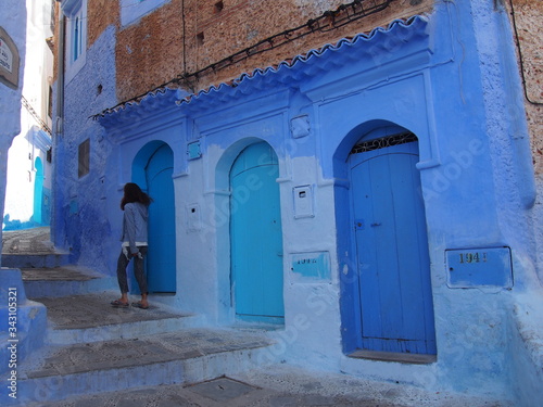 A woman and staircase in the beautiful blue old town, Medina, Chaouen (Chefchaouen), Morocc