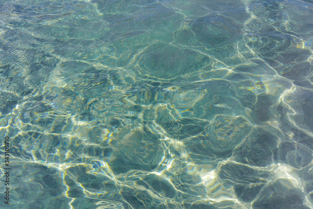Sun reflections on a clear water surface