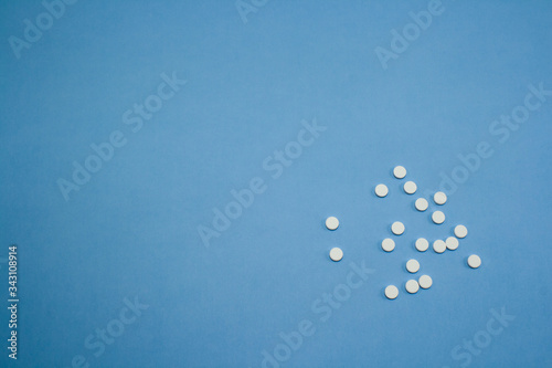White pills on blue background on the right side