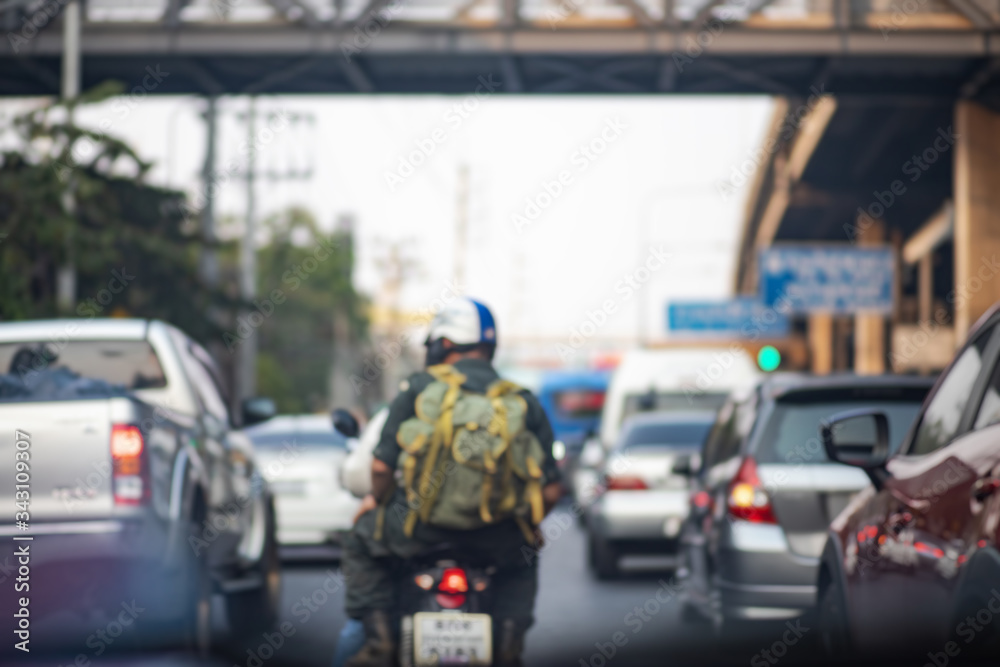 Blurry background of rear view of man driving motorcycle and may cars driving on road, Terrible traffic jam in city Blurry background of rear view of man driving motorcycle and may cars driving on road, Terrible traffic jam in city