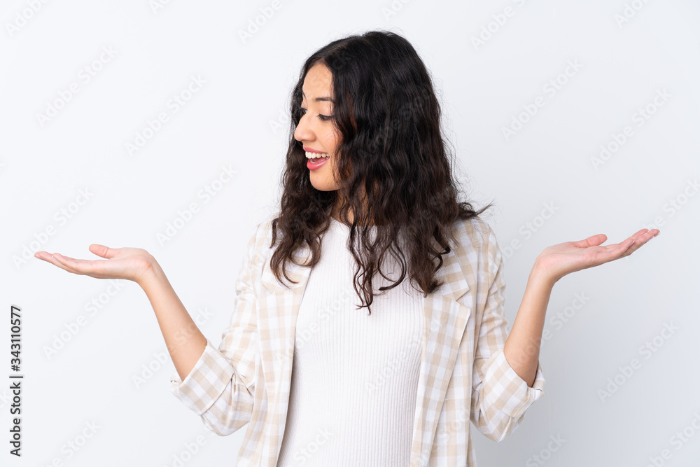 Mixed race woman over isolated white background holding copyspace with two hands Mixed race woman over isolated white background holding copyspace with two hands