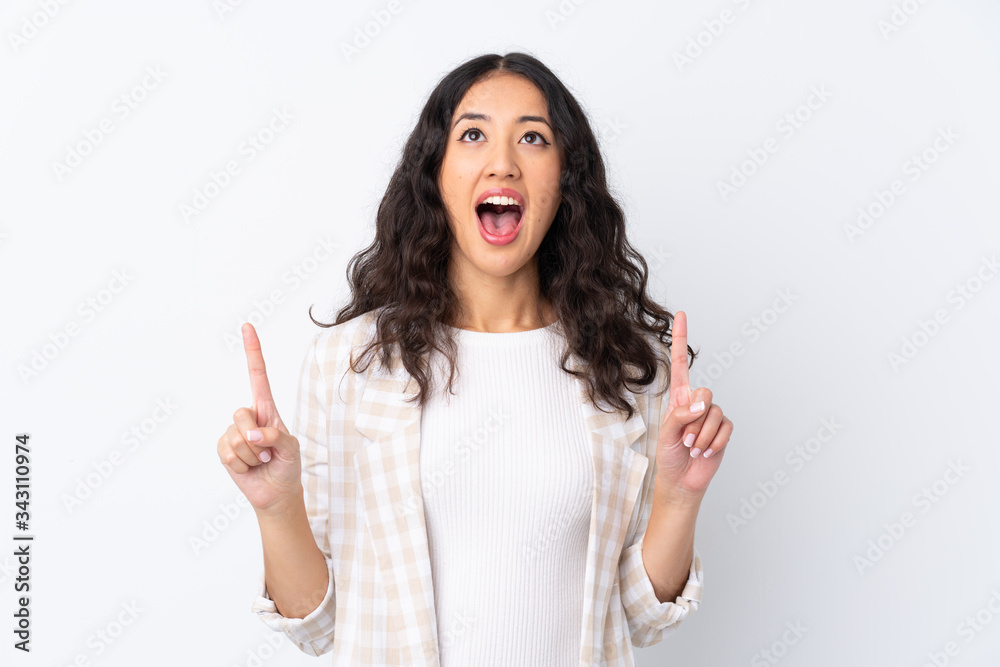 Mixed race woman over isolated white background surprised and pointing up Mixed race woman over isolated white background surprised and pointing up