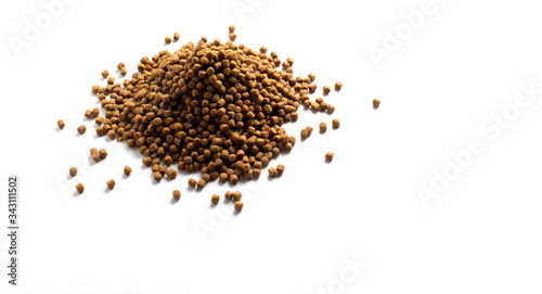 Above or Top view of animal food. Brown Dried dog food on white background. Grain pet food banner background with copy space for text design.