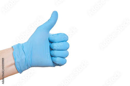 Hand in blue medical glove shows thumbs up