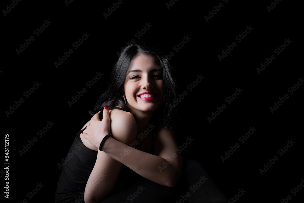 Fototapeta premium Young woman looking at camera isolated on black background. Beautiful woman portrait.