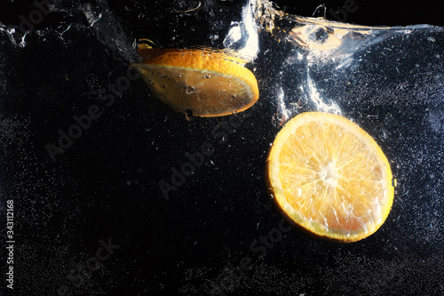 Water drops on ripe sweet orange. Fresh mandarin background with copy space for your text. Vegetarian concept. photo