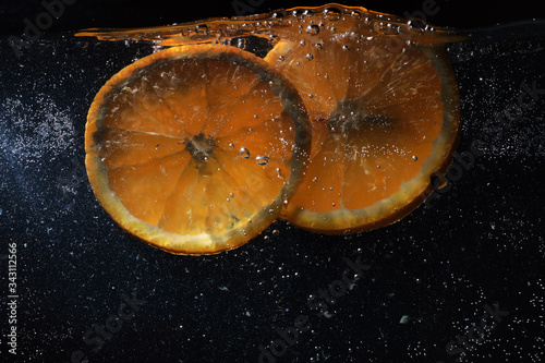 Water drops on ripe sweet orange. Fresh mandarin background with copy space for your text. Vegetarian concept. photo