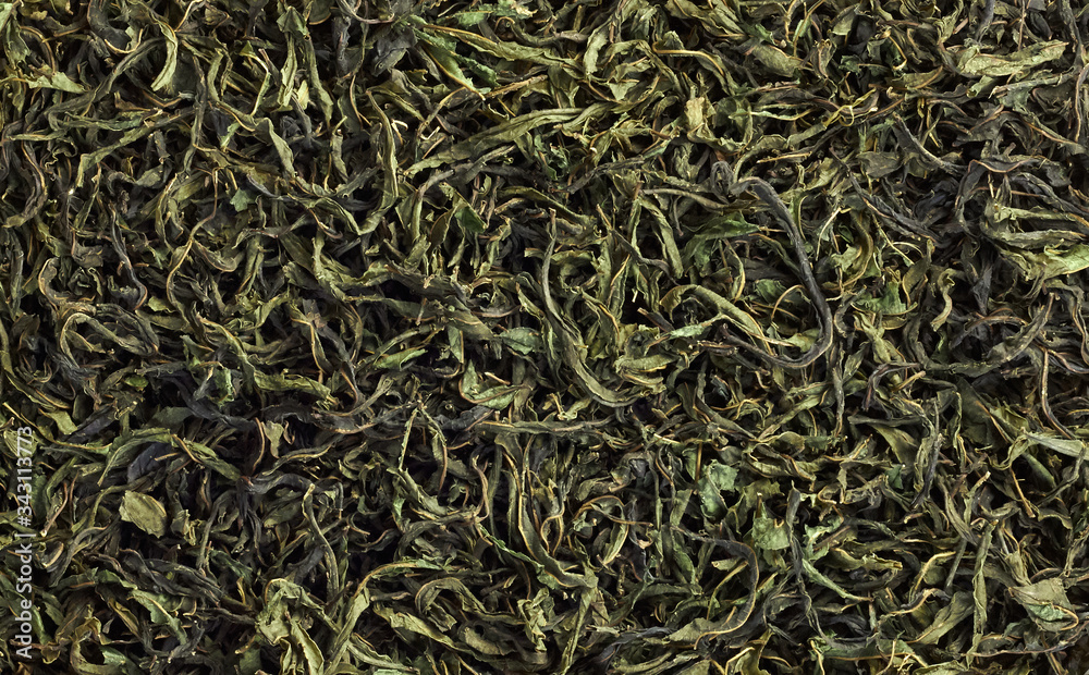 Handmade green tea made of fermented blooming sally herb, background texture, flat lay, overhead top view from above, closeup
