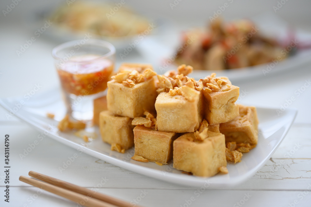 Deep fried tofu is cut into square balls on plate Deep fried tofu is cut into square balls on plate