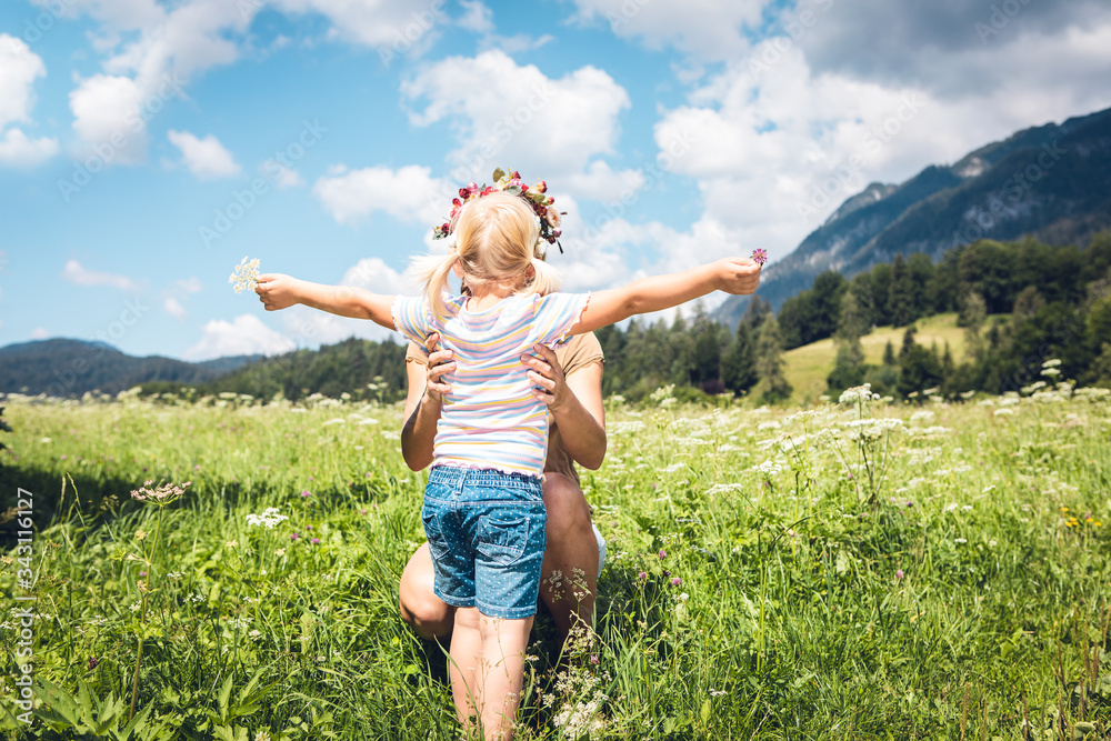 happy young woman with little girl in field happy young woman with little girl in field