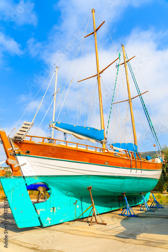 Traditional wooden sail boat in shipyard of small Greek marina, Samos island, Greece