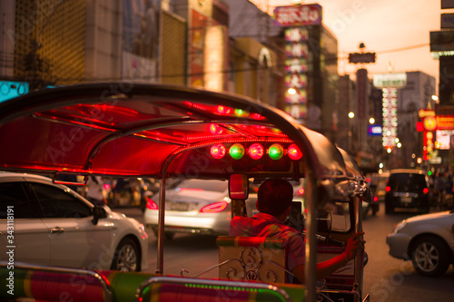 Tuk Tuk local Taxi driver is waiting for customer passenger at China Town in Bangkok, Thailand. photo