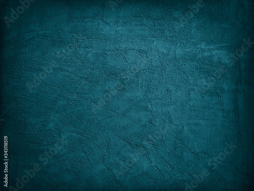 Blue green decorative abstract background. Texture of plastered concrete wall. Grunge background. The combination of the texture of a grainy rough surface and dark turquoise color. photo