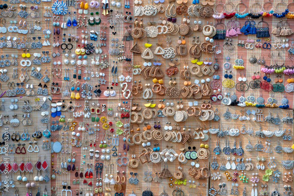 Colorful handmade earrings for sale for tourists at the street market in Hoi An old town, Vietnam