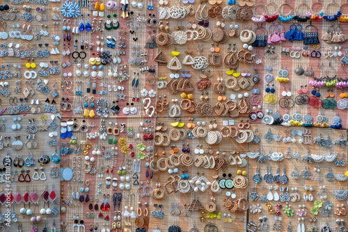 Colorful handmade earrings for sale for tourists at the street market in Hoi An old town  Vietnam