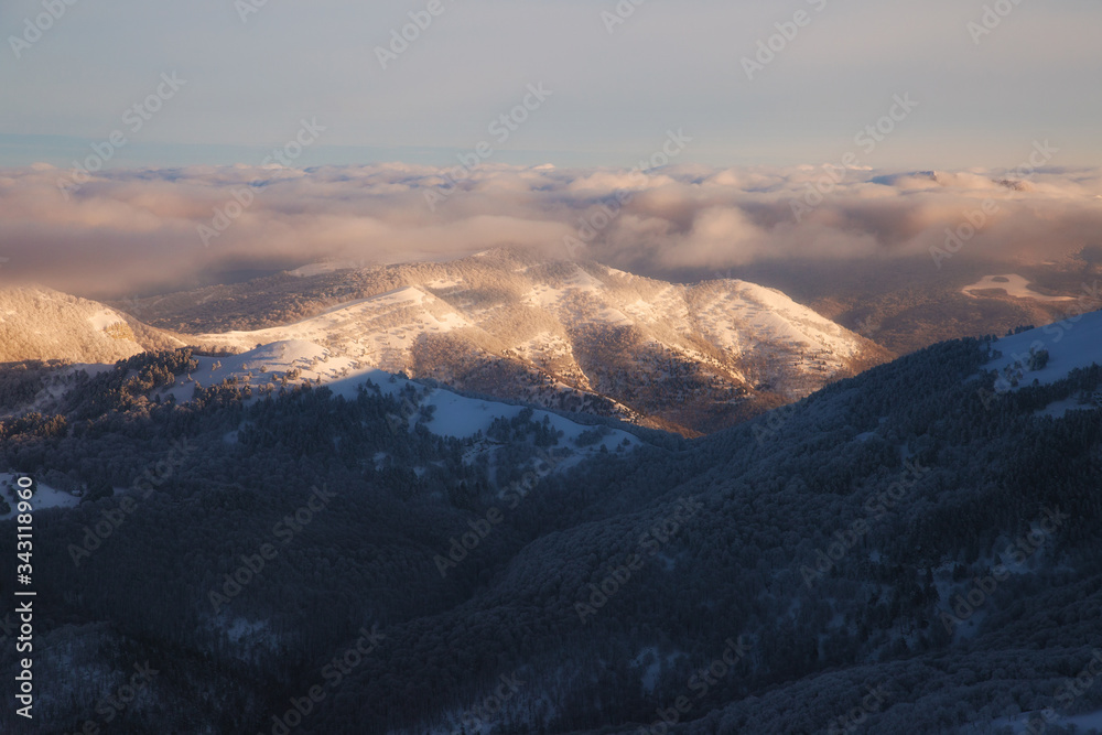 Winter mountains landscape at dawn in the morning and beautiful low clouds
