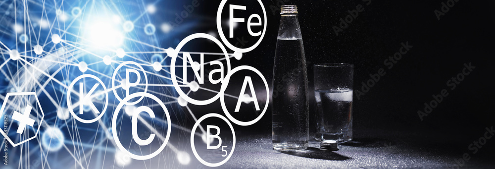 Obraz premium Close up pouring purified fresh drink water from the bottle on table in living room. Drinking water. Mineral vitamin water. Healthy, mineral-rich, refreshing water.