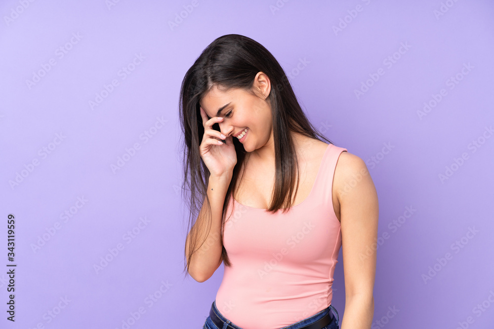 Young woman over isolated purple background laughing Young woman over isolated purple background laughing