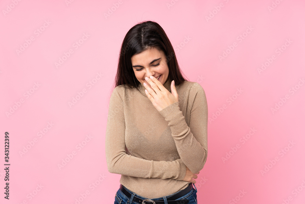 Young woman over isolated pink background smiling a lot Young woman over isolated pink background smiling a lot