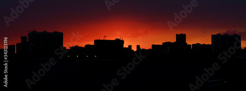 Silhouette of the Moscow city in the sping bright red sunset. The beauty of nature and the city.