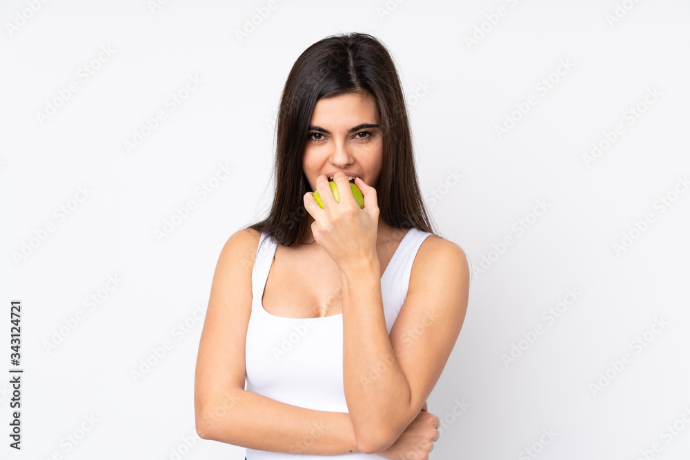 Young woman over isolated white background eating an apple Young woman over isolated white background eating an apple