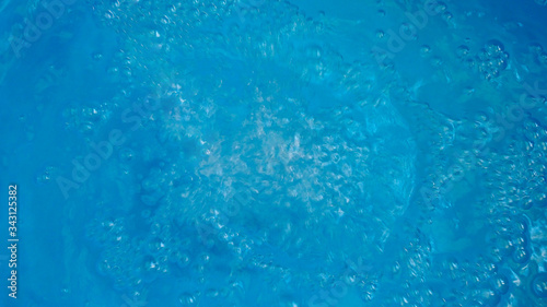 Abstract wallpaper with water surface with bubbles on blue background.