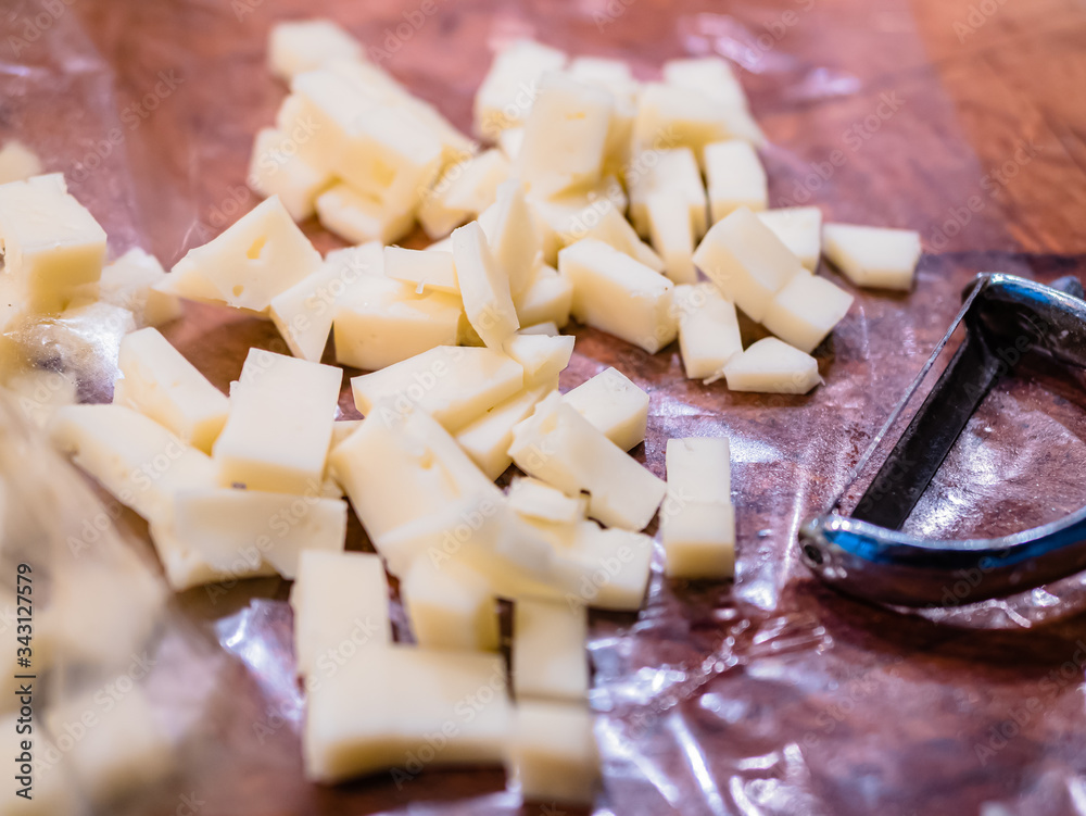 Fototapeta premium Close-up of the typical cheeses used in the recipe for making Pizzoccheri. Typical dish from Valtellina, Lombardy, Italy.
