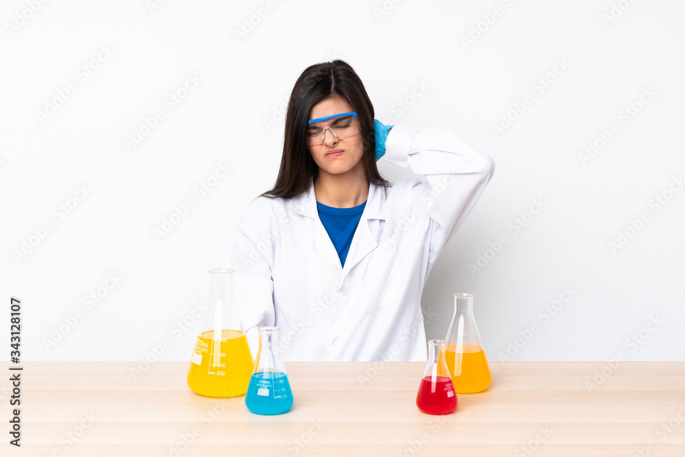 Young scientific woman in a table with neckache Young scientific woman in a table with neckache