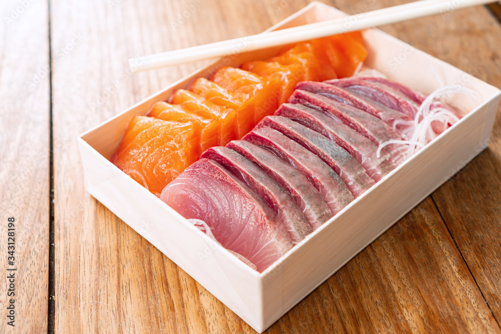 Salmon and Tuna sashimi cutting fresh and raw in Japanese style. on wooden table background, Healthy Eating and Eat Well Concept. Take away home food. Close up Salmon and Tuna sashimi cutting fresh and raw in Japanese style. on wooden table background, Healthy Eating and Eat Well Concept. Take away home food. Close up