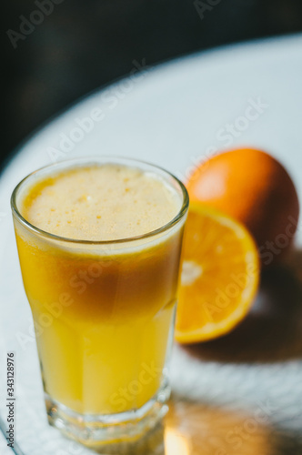 Orange juice and slices of orange fruit in glass