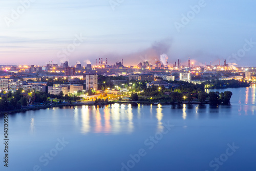 Aerial view of the evening city and metallurgical plant. White nights in the city