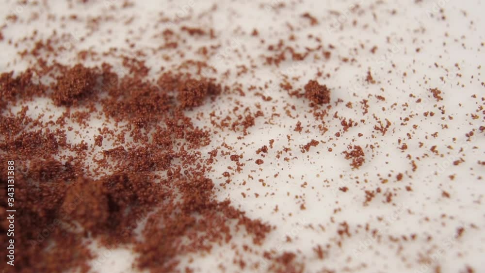 Chicory powder falls on a white surface. Natural Fragrant Drink. Macro shot. Close-up. Slow motion. The concept of an invigorating morning drink for breakfast. Chicory powder falls on a white surface. Natural Fragrant Drink. Macro shot. Close-up. Slow motion. The concept of an invigorating morning drink for breakfast.