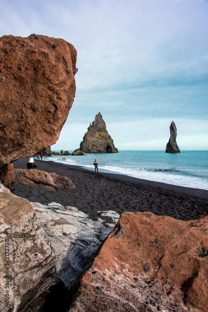 Magical majestic dramatic landscape with Reynisdrangar Sea Cliffs, stones called Troll under the Reynisfjall Mountain near Vik, Iceland. Exotic countries.