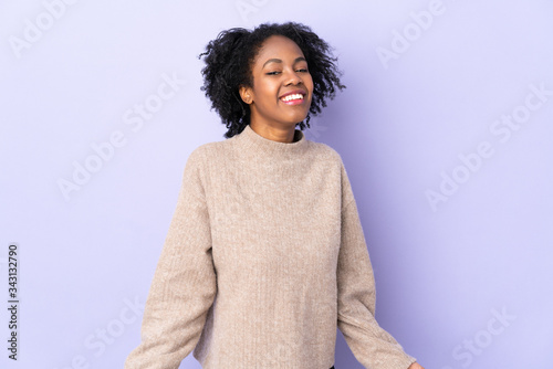 Young African American woman isolated on purple background happy and smiling © luismolinero