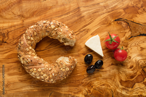 Turkish bagel, cheese, tomato, olive on black background (simit)

