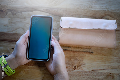 Top view, woman holding smartphone of search and select on lifestyle shopping with concept cashless socity to exchange payment photo